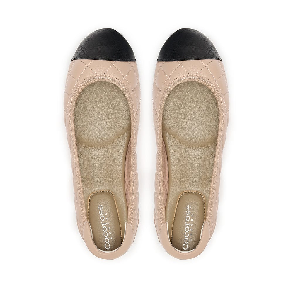 Quilted leather ballet flat in nude with black toe cap, birds eye view