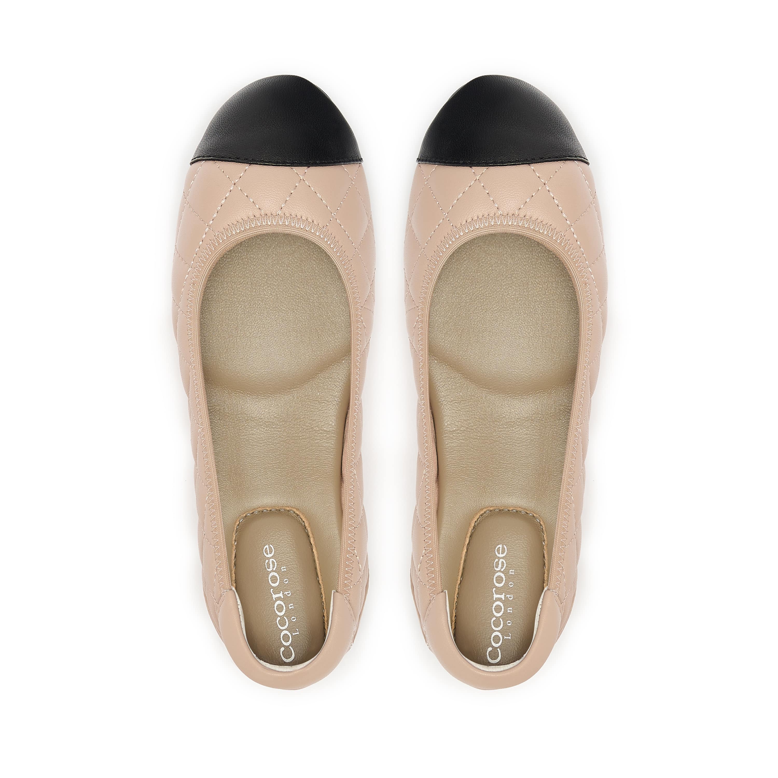 Quilted leather ballet flat in nude with black toe cap, birds eye view